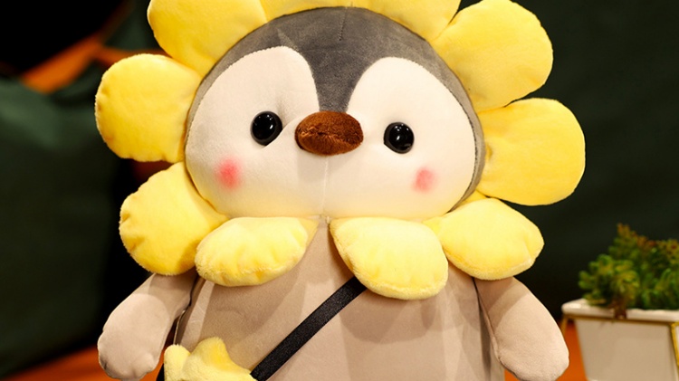 Penguin plush doll with yellow sunflower hat