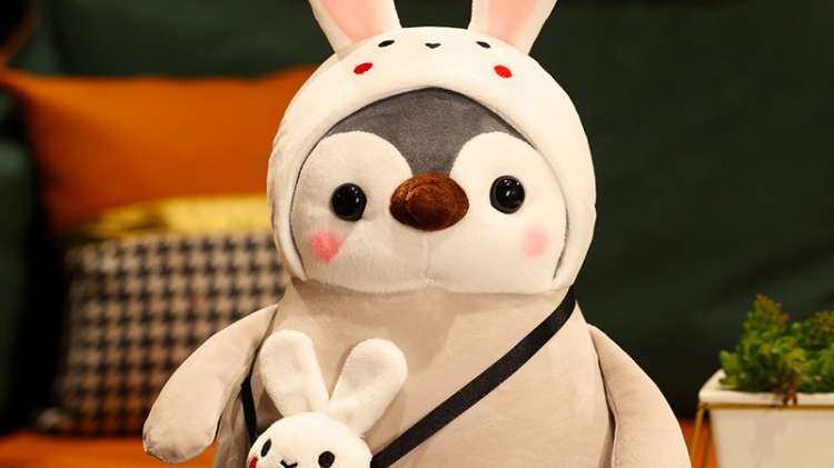 Penguin stuffed doll with white bunny hat and white bunny bag