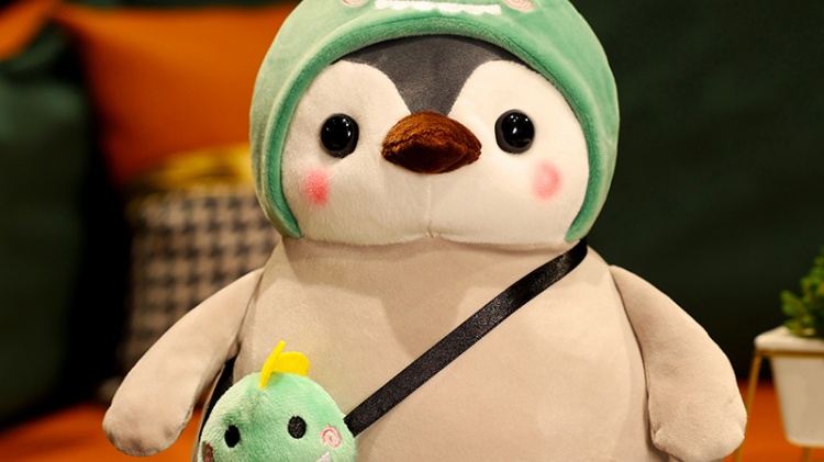 Penguin plush doll with green hat and green bag