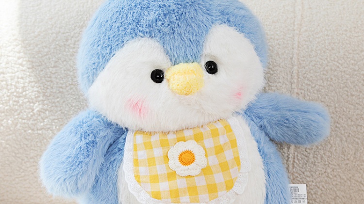 Blue and white penguin plush doll wearing yellow plaid clothes