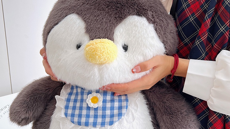 Penguin plush doll wearing blue maid outfit